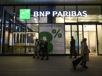 People walk past a BNP Paribas bank in Warsaw, Poland, on November 25, 2024. (