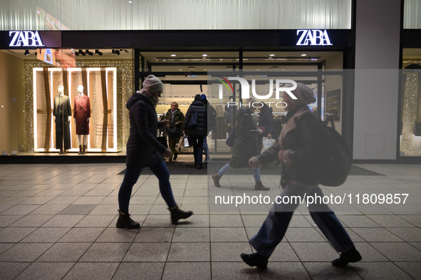 People walk past a Zara shop during Black Friday week in Warsaw, Poland, on November 25, 2024. 