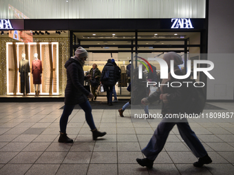 People walk past a Zara shop during Black Friday week in Warsaw, Poland, on November 25, 2024. (