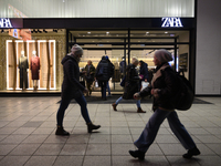 People walk past a Zara shop during Black Friday week in Warsaw, Poland, on November 25, 2024. (