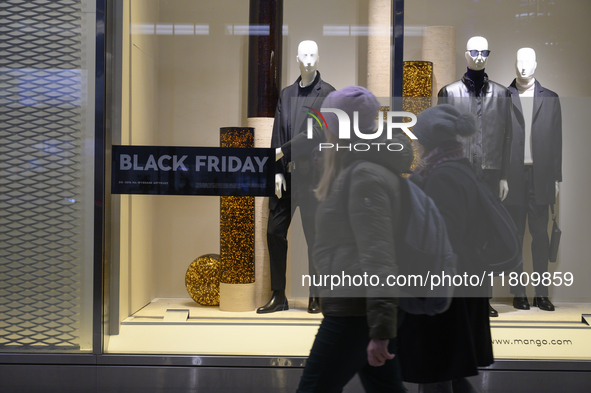 People walk past a Zara shop during Black Friday week in Warsaw, Poland, on November 25, 2024. 