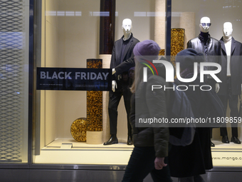 People walk past a Zara shop during Black Friday week in Warsaw, Poland, on November 25, 2024. (