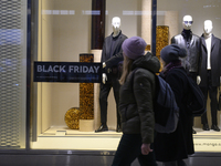 People walk past a Zara shop during Black Friday week in Warsaw, Poland, on November 25, 2024. (