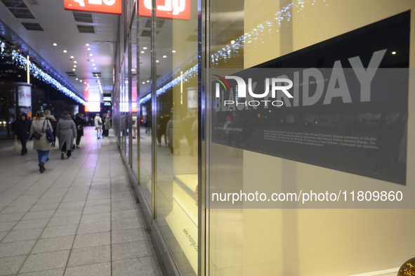 People walk past a Zara shop during Black Friday week in Warsaw, Poland, on November 25, 2024. 