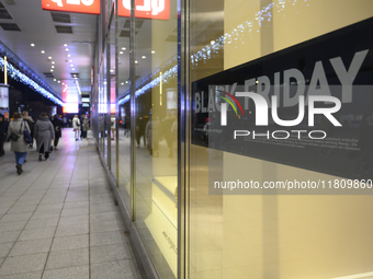 People walk past a Zara shop during Black Friday week in Warsaw, Poland, on November 25, 2024. (