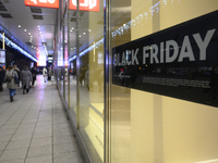 People walk past a Zara shop during Black Friday week in Warsaw, Poland, on November 25, 2024. (