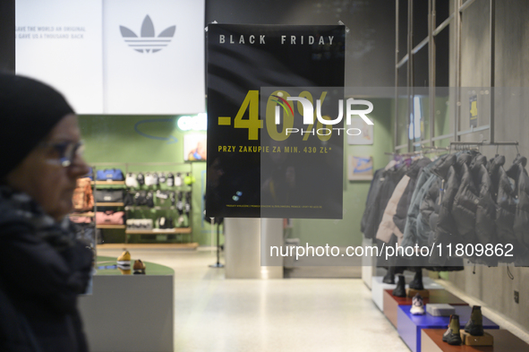 A pedestrian walks past an Adidas store during Black Friday week in Warsaw, Poland, on November 25, 2024. 