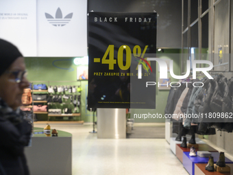 A pedestrian walks past an Adidas store during Black Friday week in Warsaw, Poland, on November 25, 2024. (