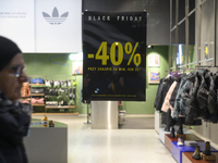 A pedestrian walks past an Adidas store during Black Friday week in Warsaw, Poland, on November 25, 2024. (