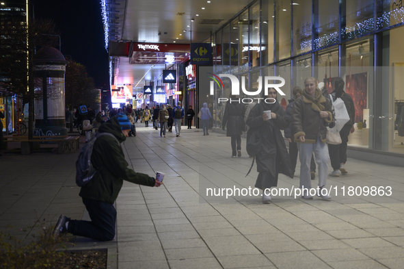 People walk past shops during Black Friday week in Warsaw, Poland, on November 25, 2024. 