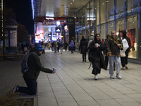 People walk past shops during Black Friday week in Warsaw, Poland, on November 25, 2024. (