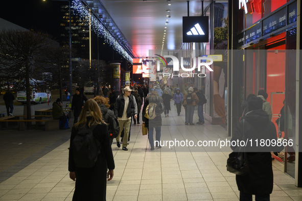 People walk past shops during Black Friday week in Warsaw, Poland, on November 25, 2024. 