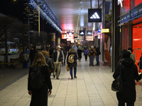 People walk past shops during Black Friday week in Warsaw, Poland, on November 25, 2024. (