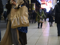 People walk past shops during Black Friday week in Warsaw, Poland, on November 25, 2024. (