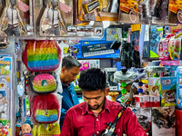 A shopkeeper holds a toy gun at a toy shop in the Bhutia Bazaar (Tibetan Market) in Nainital, Uttarakhand, India, on April 19, 2024. The Tib...