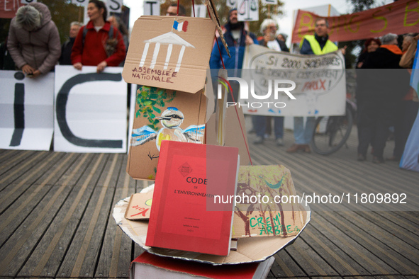 An Environment Code (French law) is pictured during the gathering. People gather in Toulouse, France, on November 25, 2024, as plaintiffs (L...