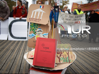 An Environment Code (French law) is pictured during the gathering. People gather in Toulouse, France, on November 25, 2024, as plaintiffs (L...