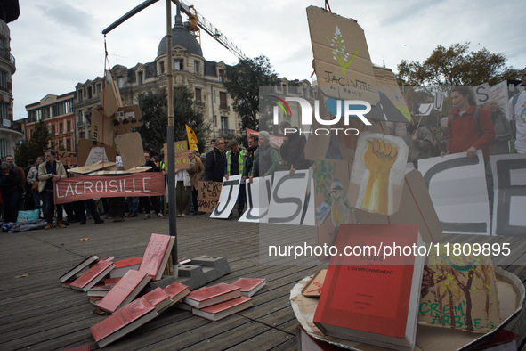 An Environment code is pictured during the gathering. People gather in Toulouse, France, on November 25, 2024, as plaintiffs (LVEL, Attac, A...