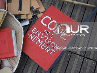 A false Environment code is pictured on the ground during the gathering. People gather in Toulouse, France, on November 25, 2024, as plainti...