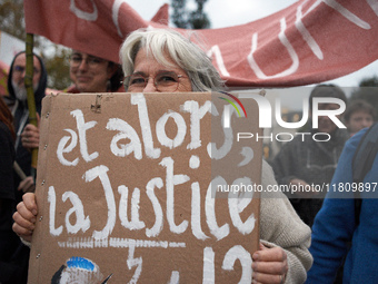 A woman holds a placard reading 'Then justice?' as people gather in Toulouse, France, on November 25, 2024, as plaintiffs (LVEL, Attac, Amis...