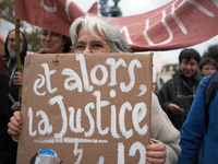 A woman holds a placard reading 'Then justice?' as people gather in Toulouse, France, on November 25, 2024, as plaintiffs (LVEL, Attac, Amis...