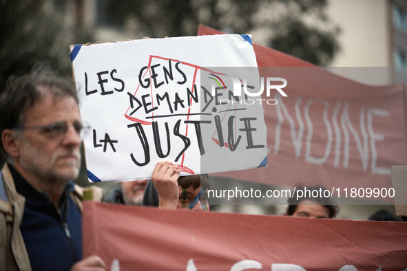 An opponent holds a cardboard sign reading 'People ask for justice'. People gather in Toulouse, France, on November 25, 2024, as plaintiffs,...