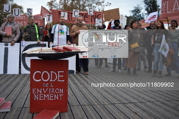 An Environment code is pictured during the gathering. People gather in Toulouse, France, on November 25, 2024, as plaintiffs (LVEL, Attac, A...