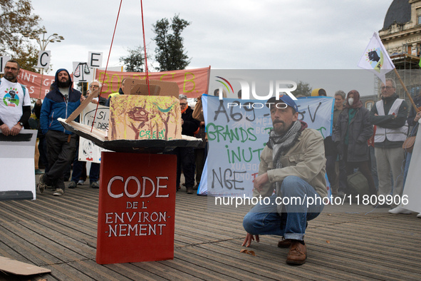 A man stands near an Environment Code (French law). People gather in Toulouse, France, on November 25, 2024, as plaintiffs (LVEL, Attac, Ami...