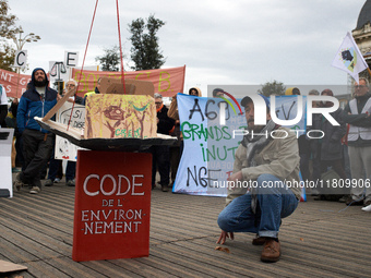 A man stands near an Environment Code (French law). People gather in Toulouse, France, on November 25, 2024, as plaintiffs (LVEL, Attac, Ami...