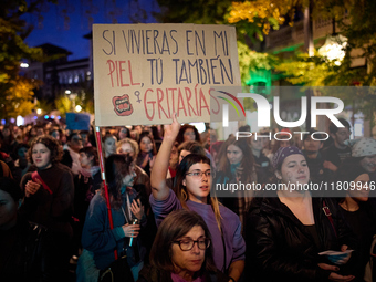 A protester holds a banner reading 'If you were living in my skin, you would scream too' during the 25N demonstration, International Day for...