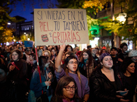 A protester holds a banner reading 'If you were living in my skin, you would scream too' during the 25N demonstration, International Day for...