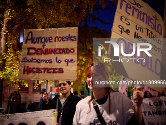 A protester holds a banner reading 'Even if you are not reported, we know what you did' during the 25N demonstration, International Day for...