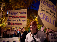 A protester holds a banner reading 'Even if you are not reported, we know what you did' during the 25N demonstration, International Day for...