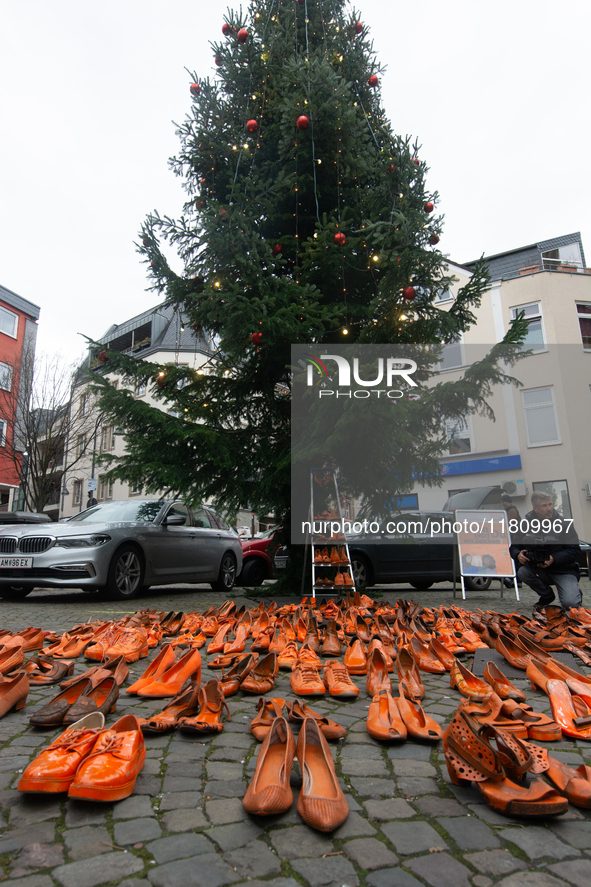 Orange shoes are displayed under a Christmas tree as a symbol against violence against women in Cologne, Germany, on November 25, 2024, duri...