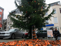 Orange shoes are displayed under a Christmas tree as a symbol against violence against women in Cologne, Germany, on November 25, 2024, duri...