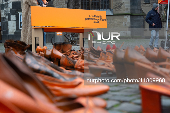 Orange shoes are displayed under a Christmas tree as a symbol against violence against women in Cologne, Germany, on November 25, 2024, duri...