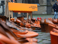 Orange shoes are displayed under a Christmas tree as a symbol against violence against women in Cologne, Germany, on November 25, 2024, duri...