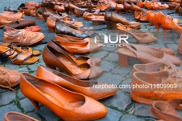 Orange shoes are displayed under a Christmas tree as a symbol against violence against women in Cologne, Germany, on November 25, 2024, duri...