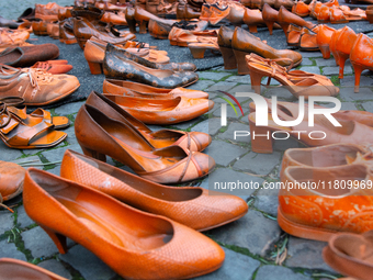 Orange shoes are displayed under a Christmas tree as a symbol against violence against women in Cologne, Germany, on November 25, 2024, duri...