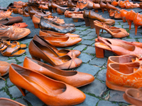 Orange shoes are displayed under a Christmas tree as a symbol against violence against women in Cologne, Germany, on November 25, 2024, duri...