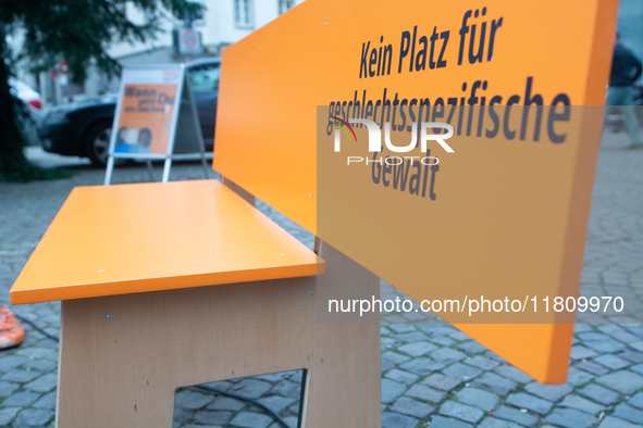 An orange bench with the message ''no place for violence against women'' is seen near a Christmas tree as a symbol against violence against...