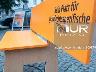 An orange bench with the message ''no place for violence against women'' is seen near a Christmas tree as a symbol against violence against...