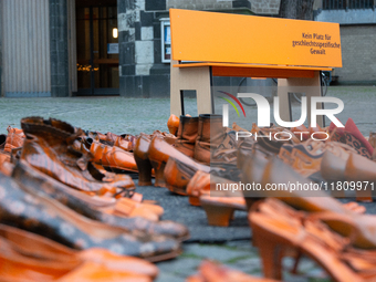 Orange shoes are displayed under a Christmas tree as a symbol against violence against women in Cologne, Germany, on November 25, 2024, duri...