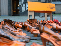 Orange shoes are displayed under a Christmas tree as a symbol against violence against women in Cologne, Germany, on November 25, 2024, duri...