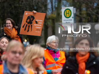 A hundred participants take part in a demonstration for International Women's Day in Bonn, Germany, on November 25, 2024, to raise awareness...