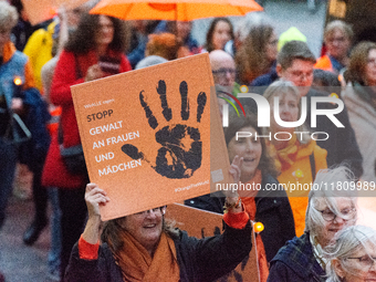 A hundred participants take part in a demonstration for International Women's Day in Bonn, Germany, on November 25, 2024, to raise awareness...