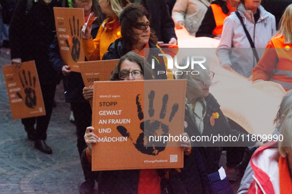 A hundred participants take part in a demonstration for International Women's Day in Bonn, Germany, on November 25, 2024, to raise awareness...