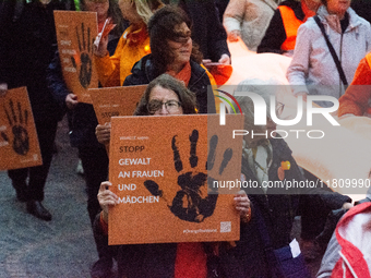 A hundred participants take part in a demonstration for International Women's Day in Bonn, Germany, on November 25, 2024, to raise awareness...