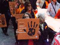 A hundred participants take part in a demonstration for International Women's Day in Bonn, Germany, on November 25, 2024, to raise awareness...