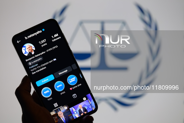 Benjamin Netanyahu's social media is displayed on a smartphone with the International Criminal Court logo visible in the background in this...